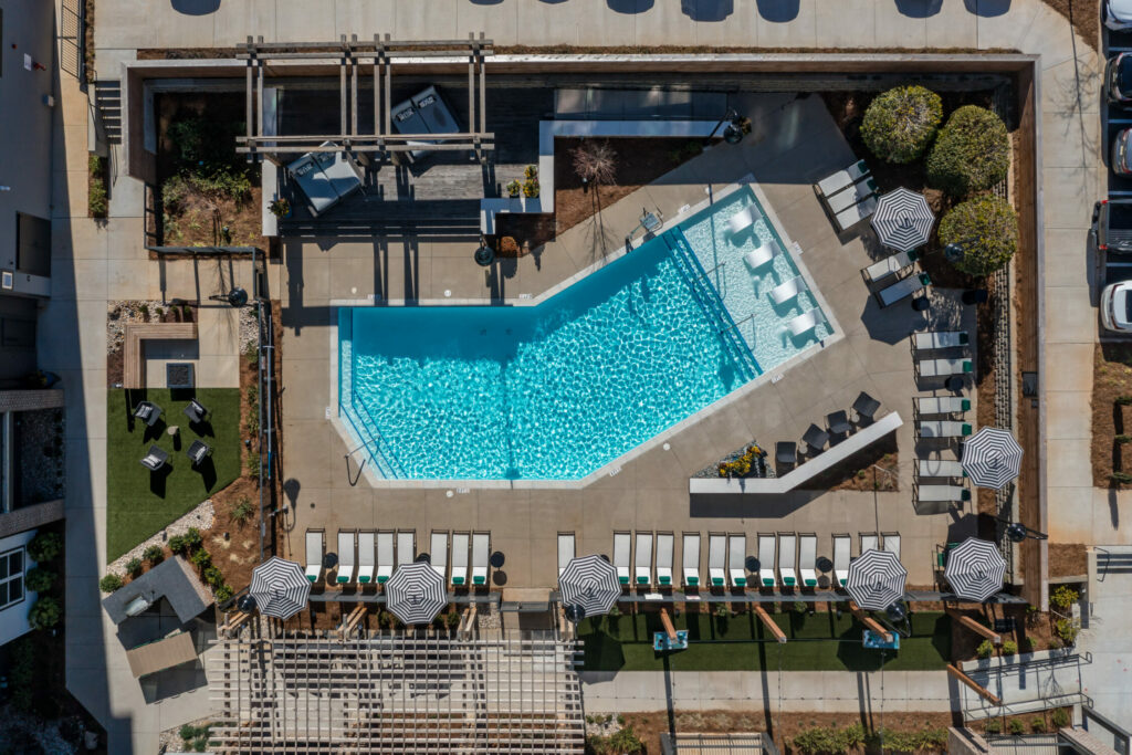 The Epitome of Stylish Living - overhead view of the saltwater pool with sun ledge, poolside bar, and firepit